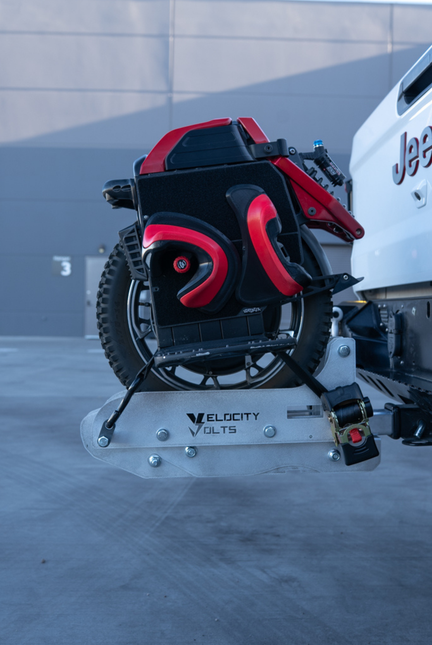 Velocity Volts EUC Carrier holding a red and black electric unicycle upright on a Jeep Gladiator hitch