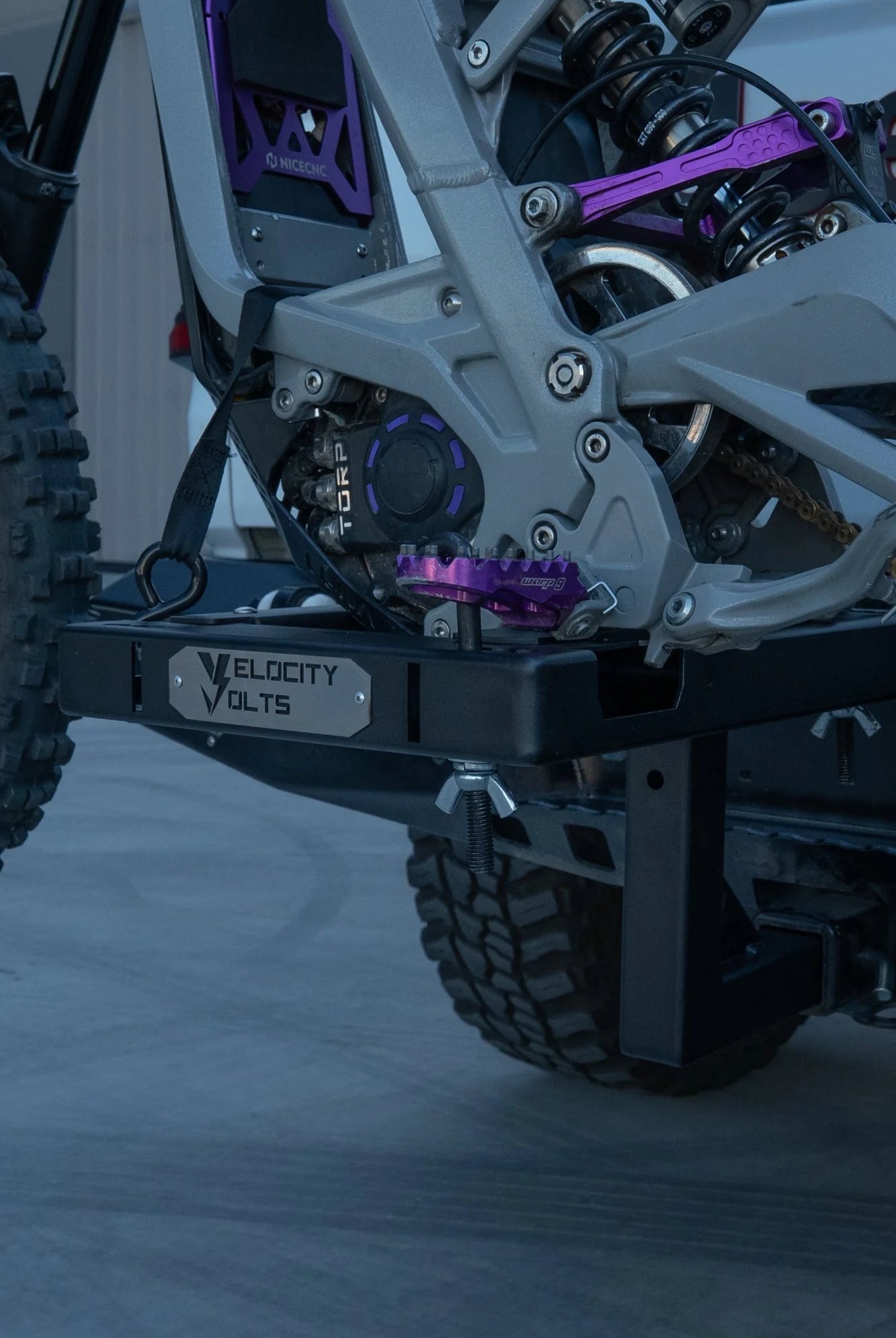 Surron Light Bee electric dirt bike on a height adjustable hitch rack