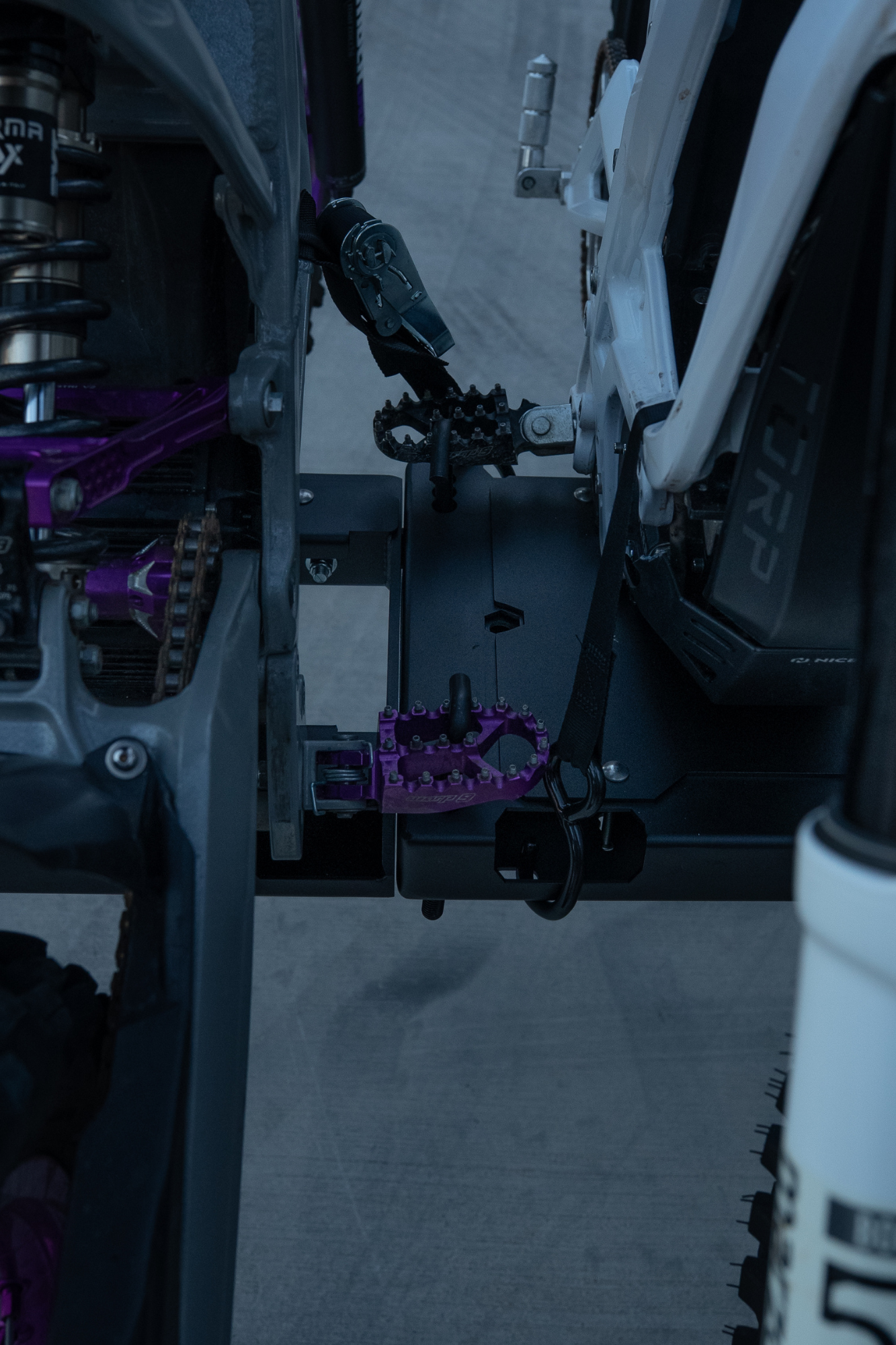 Foot-peg anchor mount on an E Ride Pro and 79BIKE e-moto hitch rack