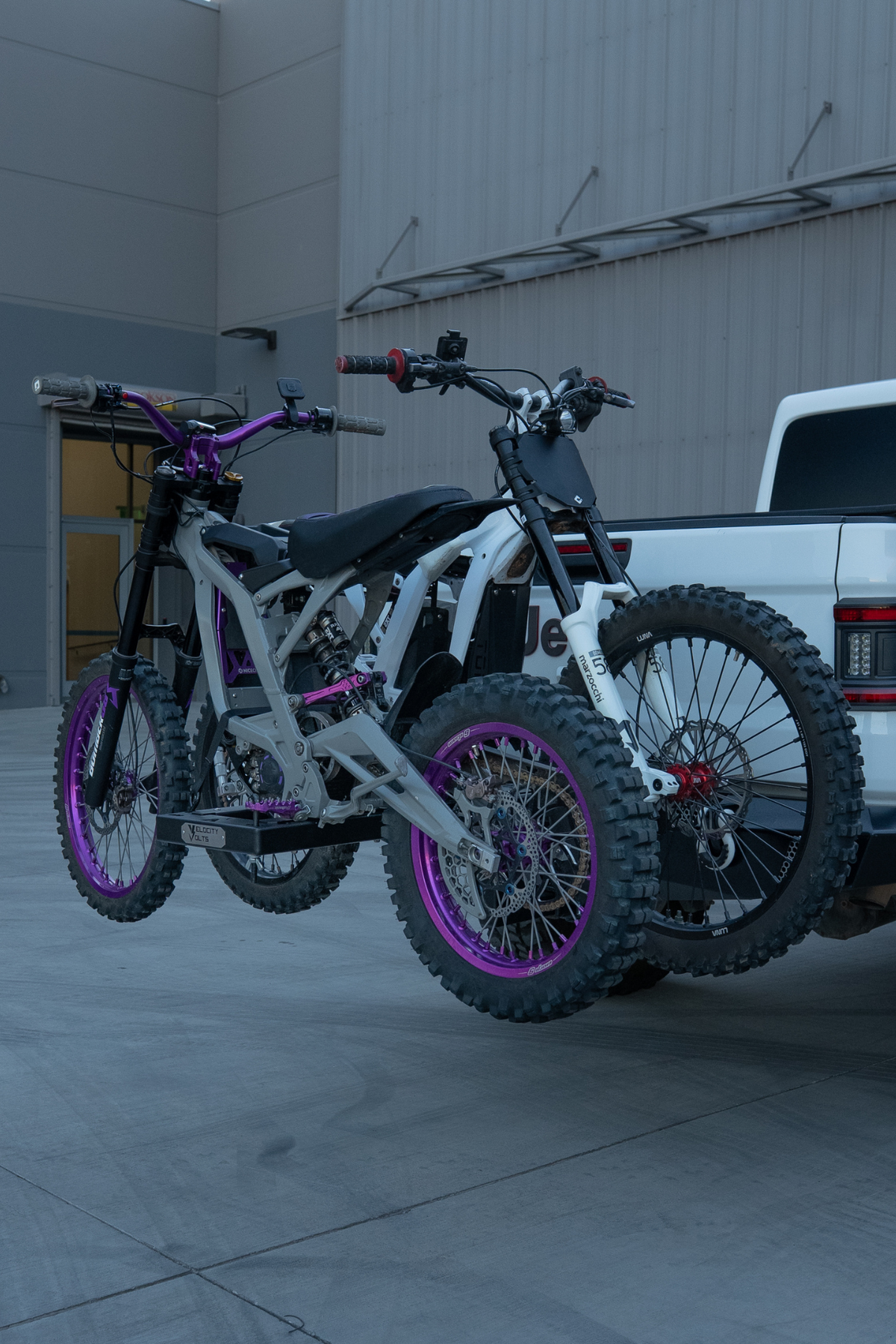 Surron Ultra Bee and Talaria e-moto hitch rack carrying two electric dirt bikes