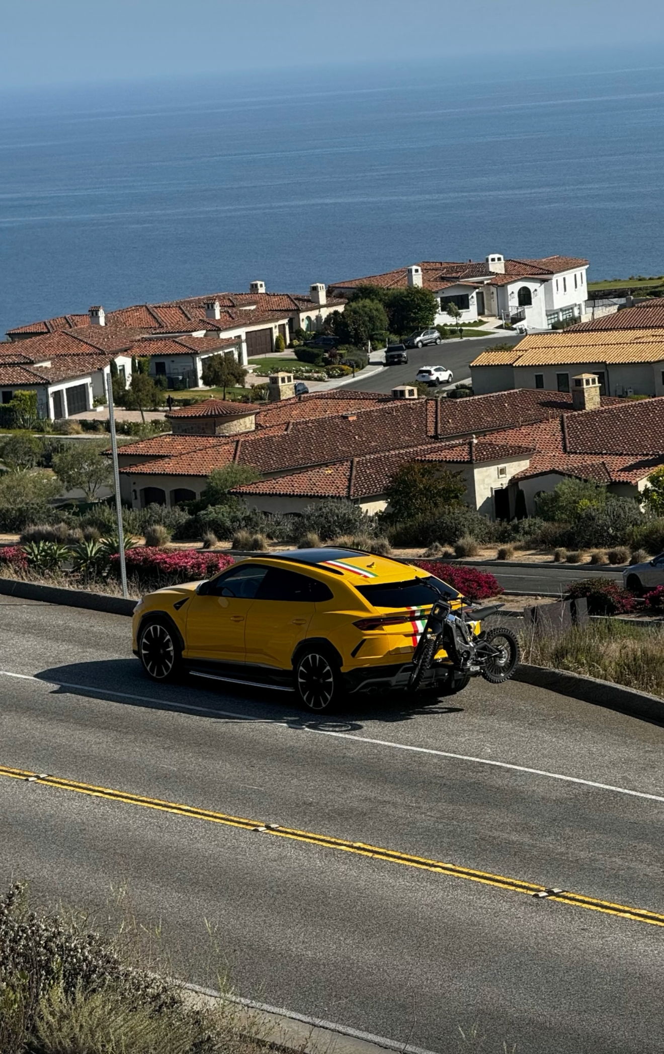 velocity volts bike rack holding eridepro on a lamborghini charge carrier emoto hitch carrier